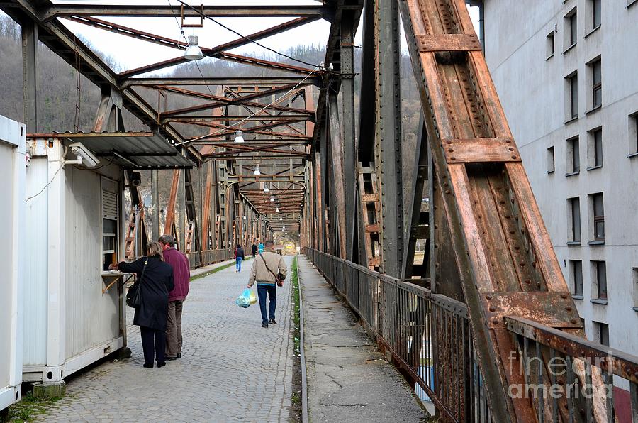 People crossing old Yugoslav weathered metal bridge crossing in Bosnia Hercegovina Photograph by Imran Ahmed