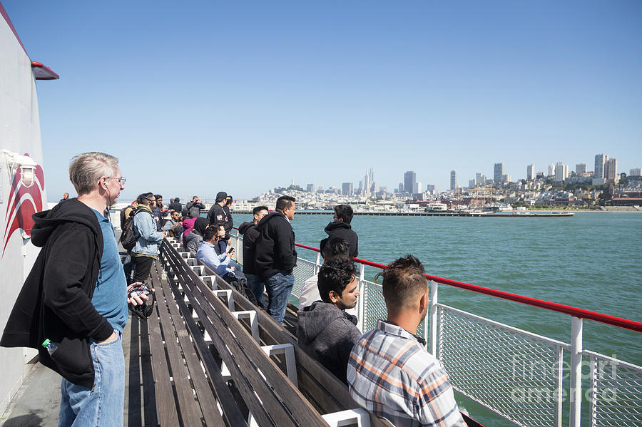 People enjoy the view of the San Francisco skyline from a cruise Photograph by Didier Marti