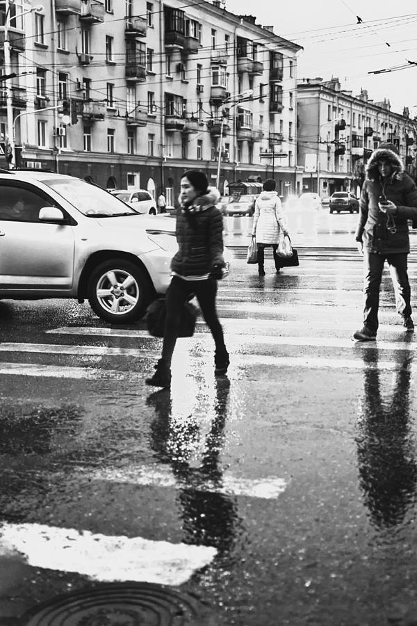 People Walk Across a Road in Reflections of Rain Photograph by John Williams