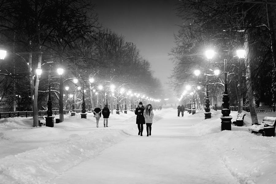People Walking at Night in Snow Photograph by John Williams