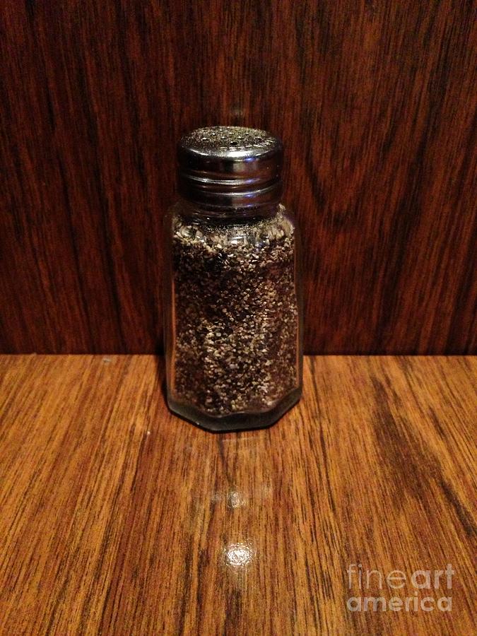 Pepper Shaker Surrounded By Wood Formica Photograph by Jenny Forker
