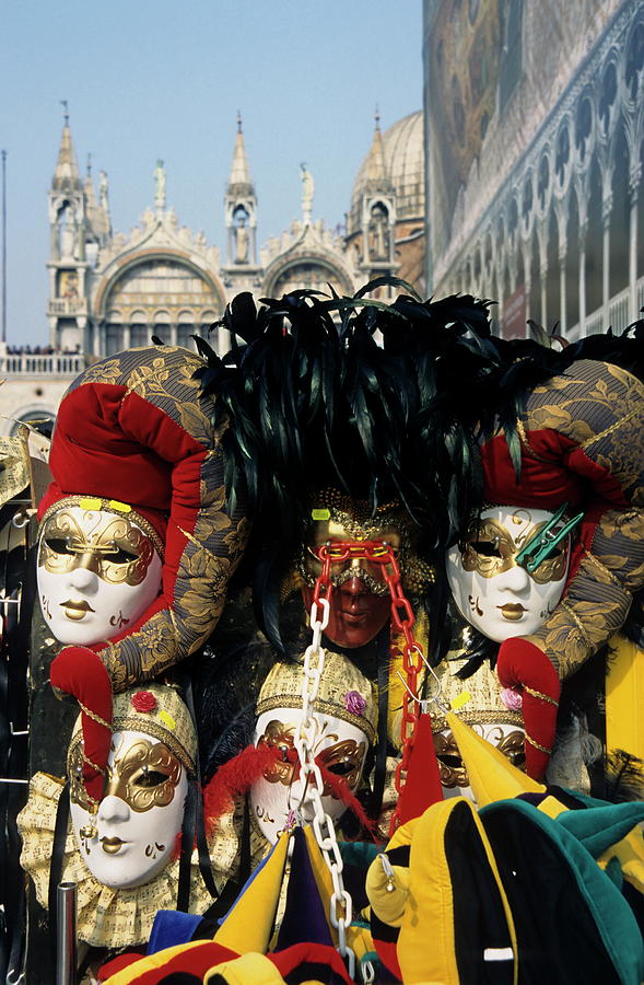 Person surrounded by elaborate masks for sale on St Marks Basilica Photograph by Sami Sarkis
