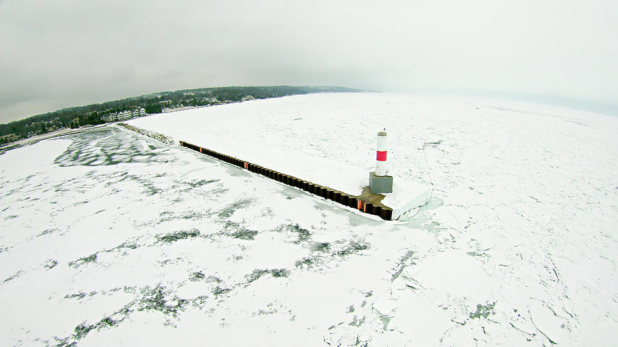 Petoskey Harbor Breakwater in spring with frozen lake  Photograph by Alex Grichenko