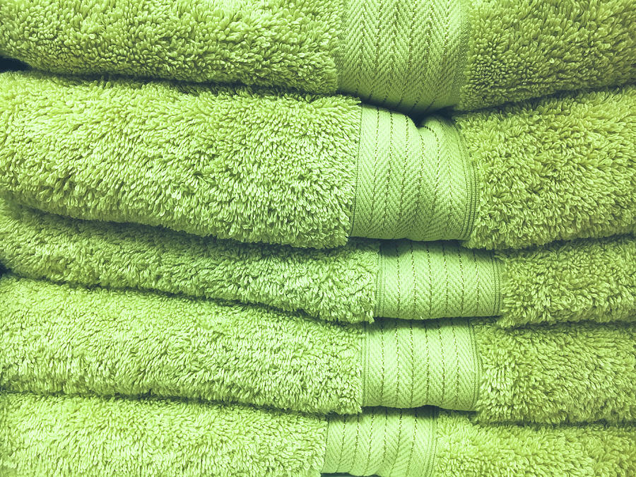 Pile of green towels Photograph by Tom Gowanlock