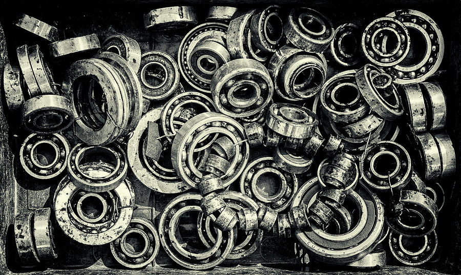 Pile of Old Rusty Ball Bearing Wheels Photograph by John Williams