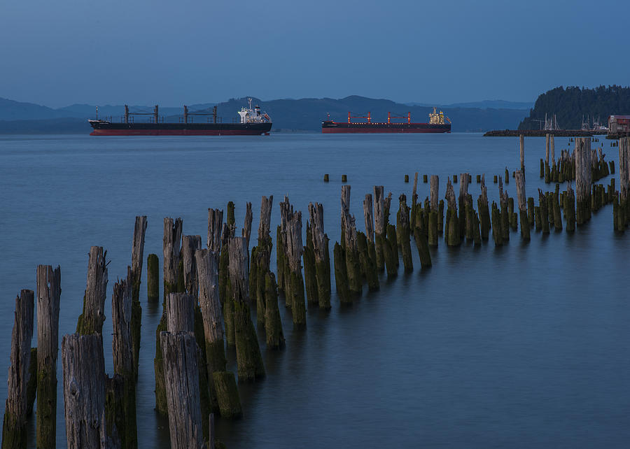 Pilings and Ships at Dusk Photograph by Robert Potts