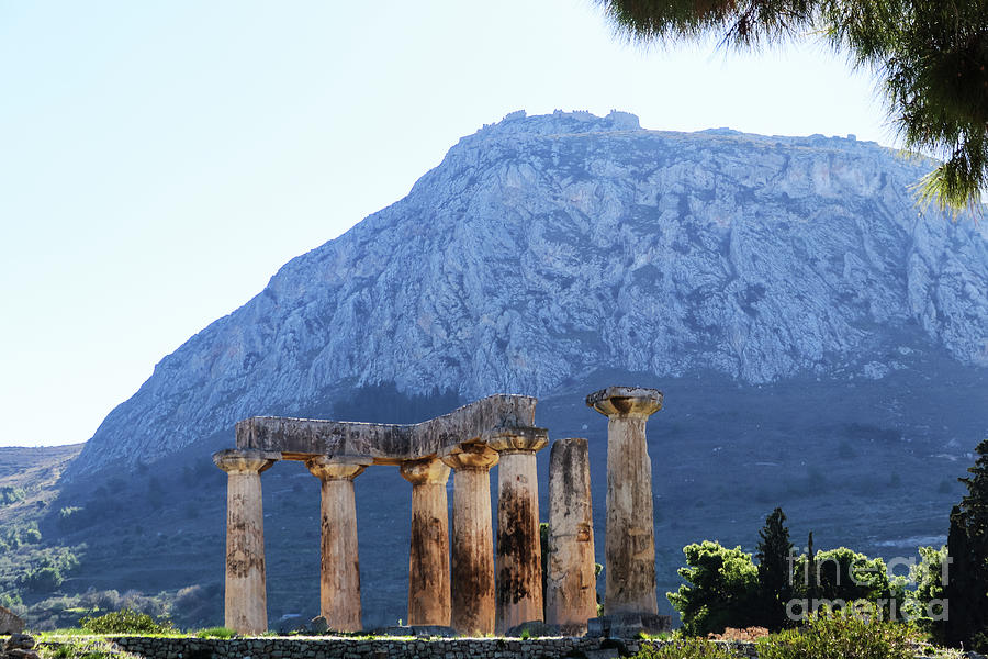 Pillars of Temple of Apollo in Corith, Greece, with Acrocorinth in background Photograph by Susan Vineyard
