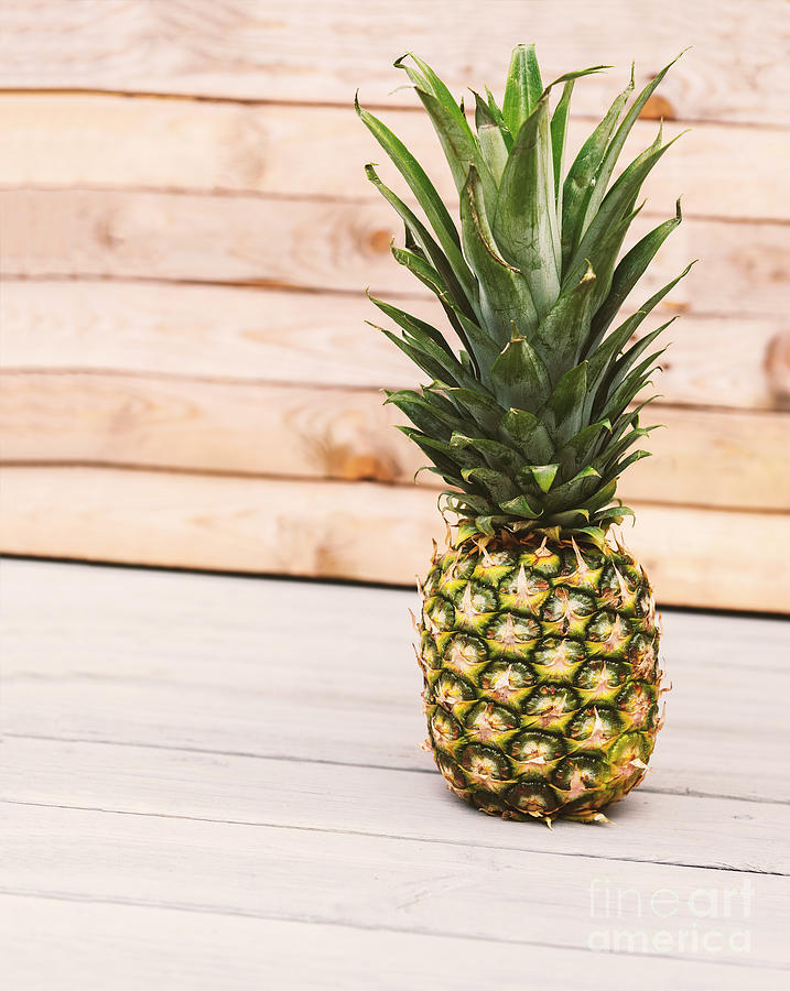 Pineapple on wooden background Photograph by Sophie McAulay