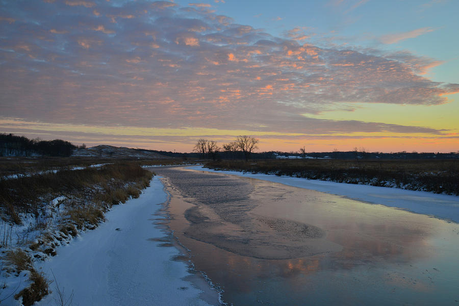 Pink Sunset Clouds Reflect in Frozen Nippersink Creek Photograph by Ray Mathis