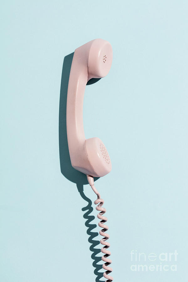 Pink telephone on a blue background. Photograph by Michal Bednarek
