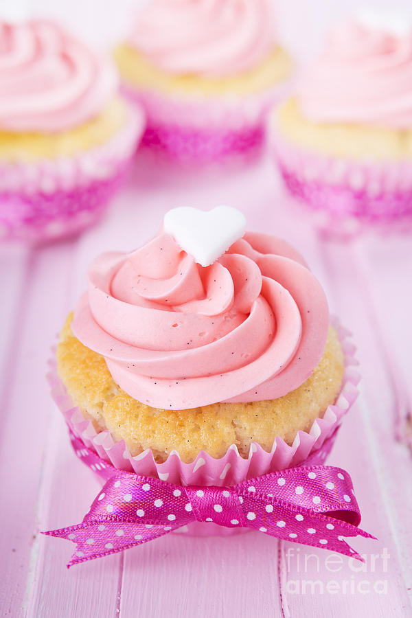 Valentines Day Photograph - Pink Valentine cupcakes on a rustic pink table by Sara Winter