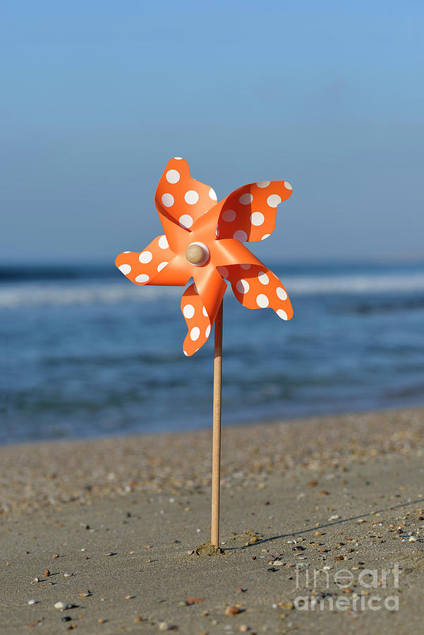 Pinwheel on a beach Photograph by George Atsametakis