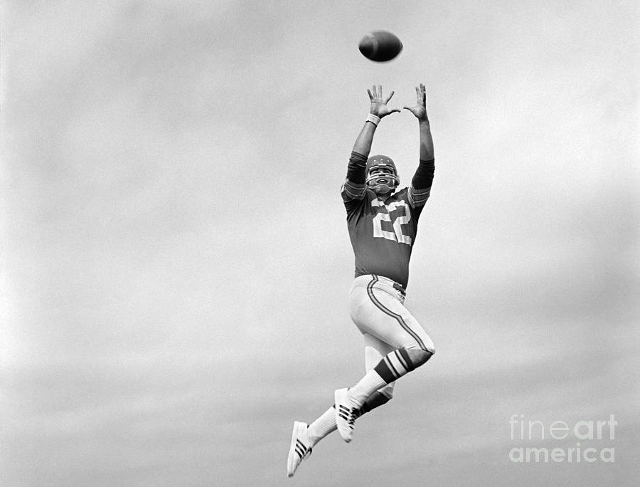 Football Photograph - Player Jumping To Catch Football by H Armstrong Roberts and ClassicStock