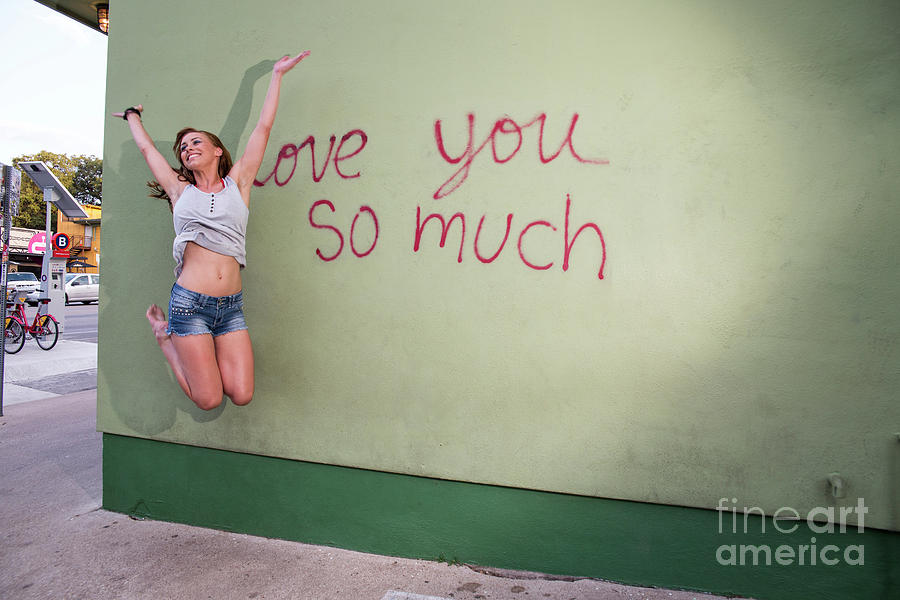 Austin Photograph - Playful local South Austin woman jumps for joy at the i love you by Dan Herron