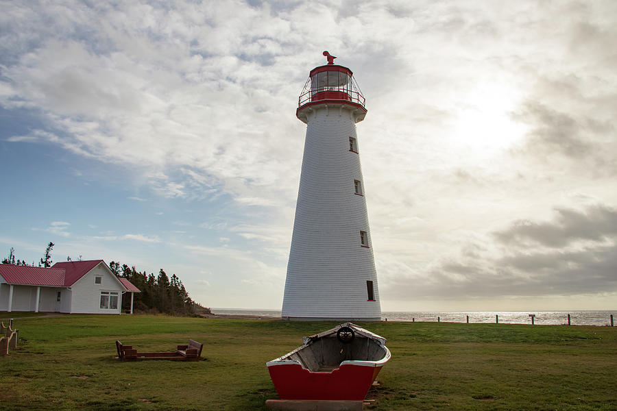 Point Prim Lighthouse, PEI and old wooden rowboat Photograph by Karen Foley