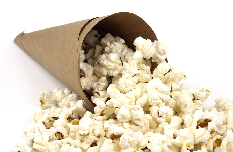 Popcorn Photograph - Popcorn in paper cone by Blink Images