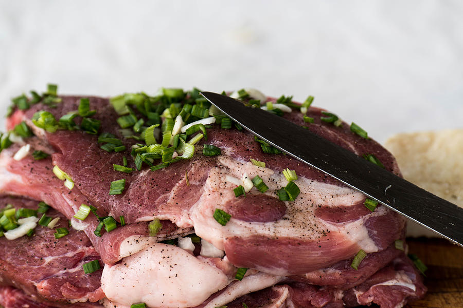 Background Photograph - Pork meat with green garlik and knife by Adrian Bud Background Photograph - Pork meat with green garlik and knife by Adrian Bud