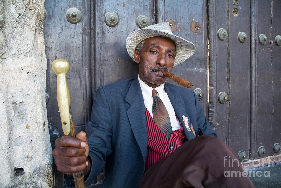 Hat Photograph - Portrait of a man wearing a 1930s-style suit and smoking a cigar in Havana by Sami Sarkis