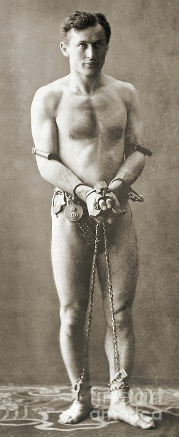 Up Movie Photograph - Portrait of Harry Houdini in chains, circa 1900 by American School