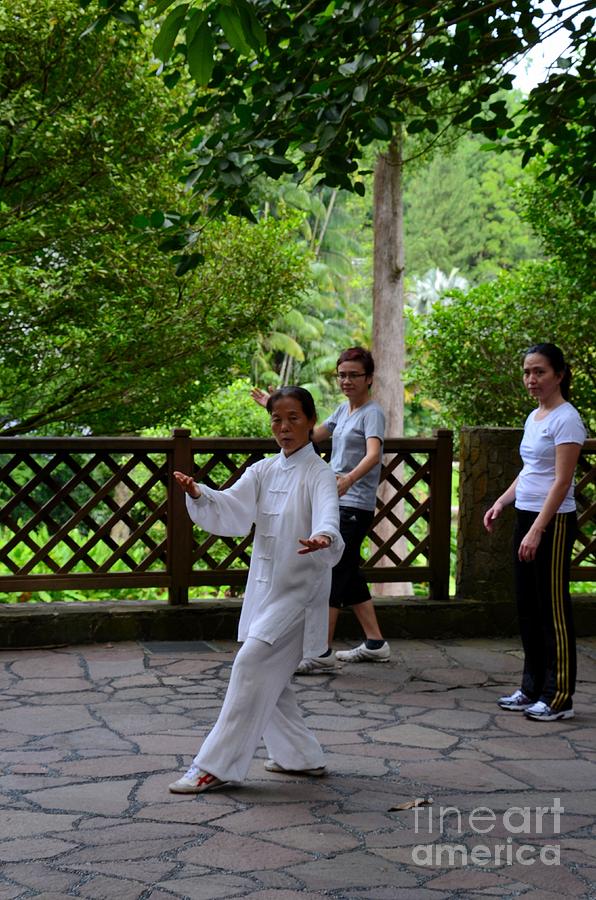 Practising early morning Tai Chi exercise in Singapore park Photograph by Imran Ahmed