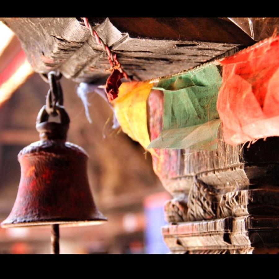 Prayer Flags And Bell At A Tiny Temple Photograph by Lorelle Phoenix