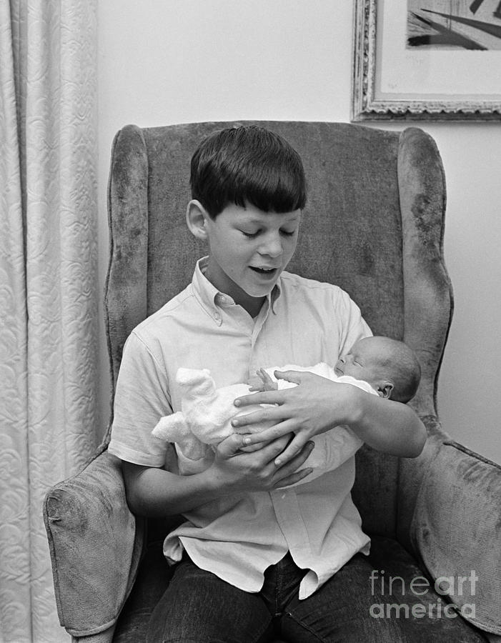 Pre-teen Boy Holding New Sister, C.1960s Photograph by H. Armstrong Roberts/ClassicStock