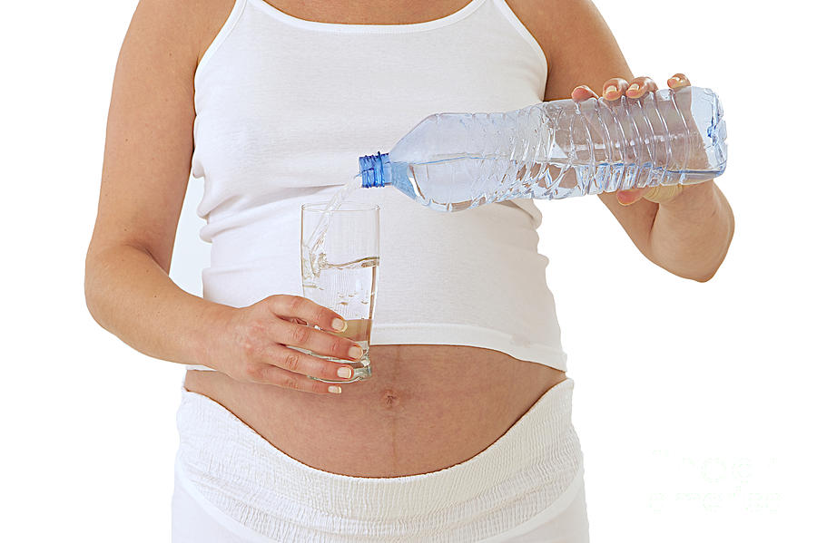 Pregnant Woman Drinking Water Photograph by Jean-Paul Chassenet
