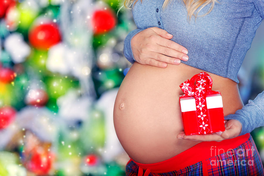 Pregnant woman with Christmas gift Photograph by Anna Om