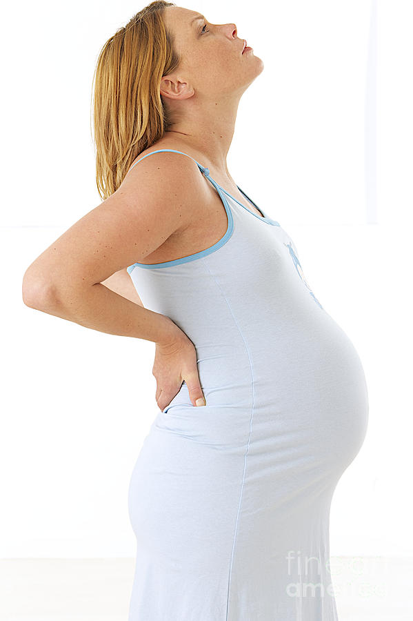 Pregnant Woman With Lower Back Pain Photograph by Jean-Paul Chassenet