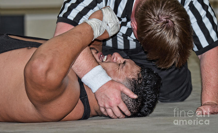 Rope Photograph - Pro Wrestler Jeff Cobb Being Tended to by Referee Sparkey Ballard by Jim Fitzpatrick