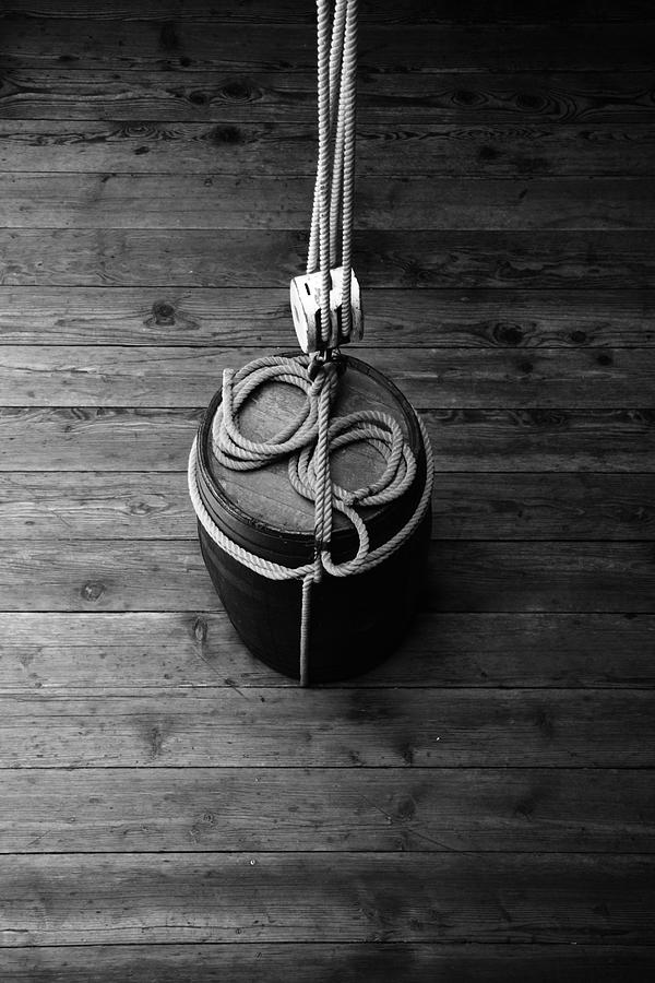 Pulley And Barrel - Black And White Photograph by Kreddible Trout