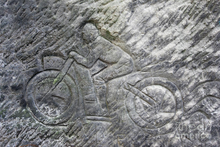 Racer on a motorbike - old rock relief Photograph by Michal Boubin