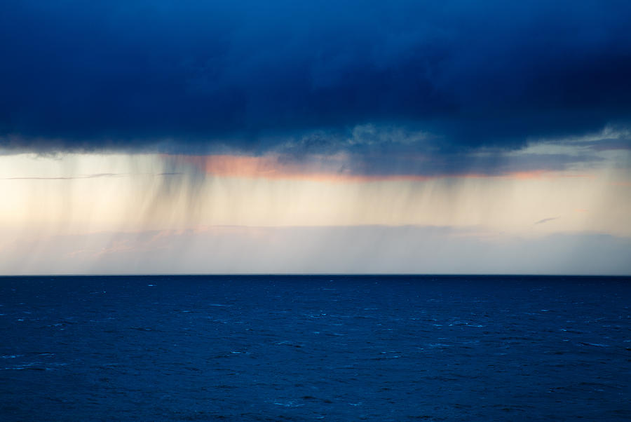 Rain on the horizon at Strumble Head Photograph by Ian Middleton