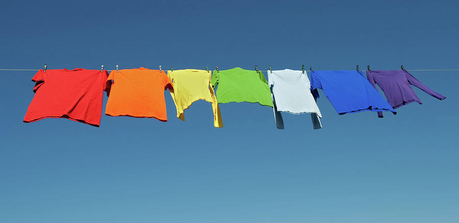 Summer Photograph - Rainbow laundry, bright shirts on a clothesline by GoodMood Art