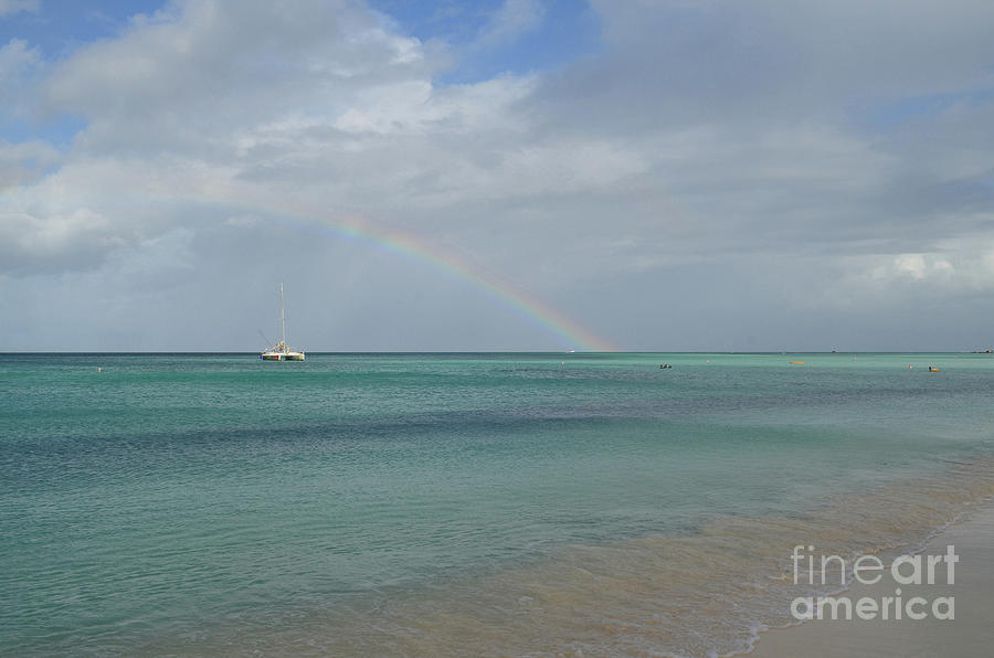 Rainbow on the Horizon with a Boat in Aruba Photograph by DejaVu Designs