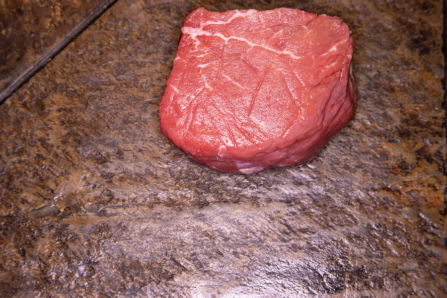 Raw filet mignon steak on slate Photograph by Karen Foley