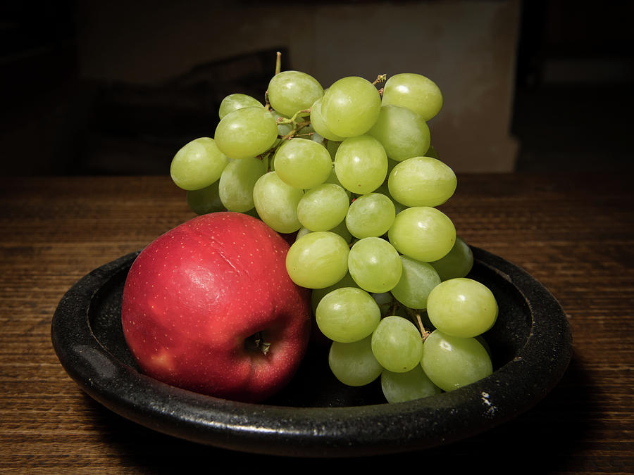 Red Apple And Green Grapes On A Black Plate Photograph