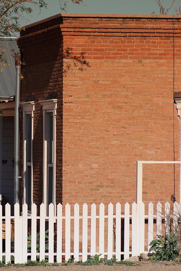 Red Brick Building and White Picket Fence Photograph by Colleen Cornelius