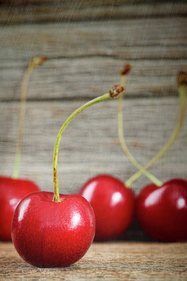 Red cherries on barn wood Photograph by Sandra Cunningham