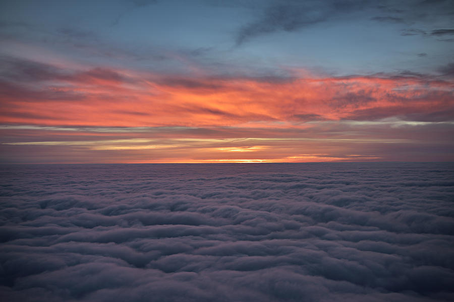 Red cloud sunrise above the clouds from a jet airplane Photograph by Reimar Gaertner