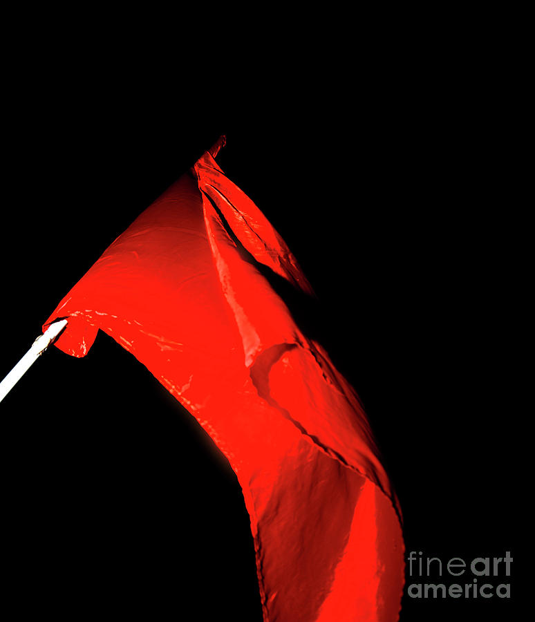 Red flag on black background Photograph by Ilan Rosen
