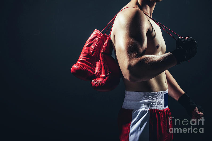 Red gloves hanging on the boxers back. Photograph by Michal Bednarek