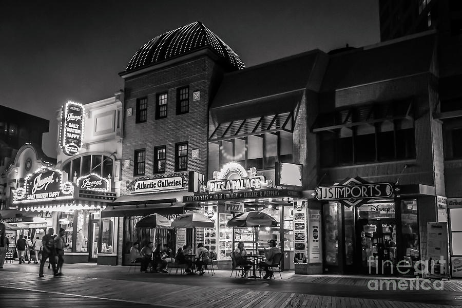 Relaxing night on the boardwalk - monochrome Photograph by Claudia M Photography