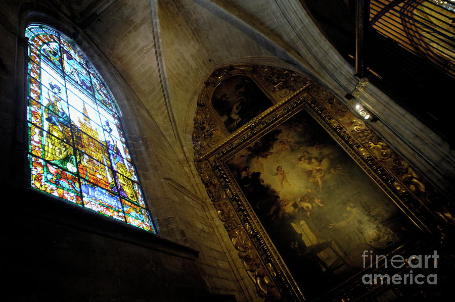 Religious painting and stained glass window inside a chapel at the Seville Cathedral Photograph by Sami Sarkis
