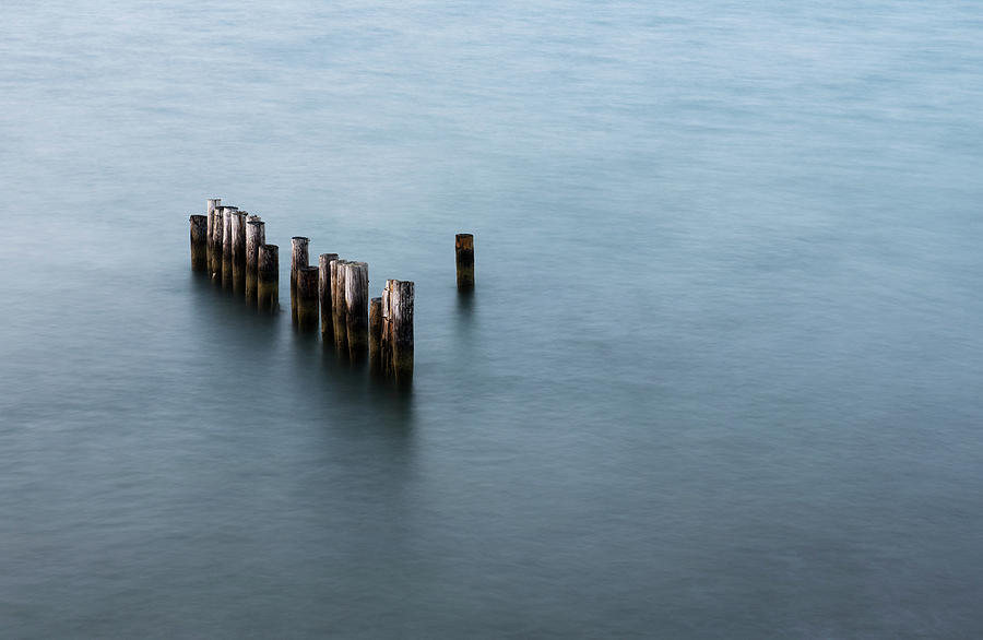 Remains of a wooden Pier or Jetty on a calm sea Photograph by Michalakis Ppalis
