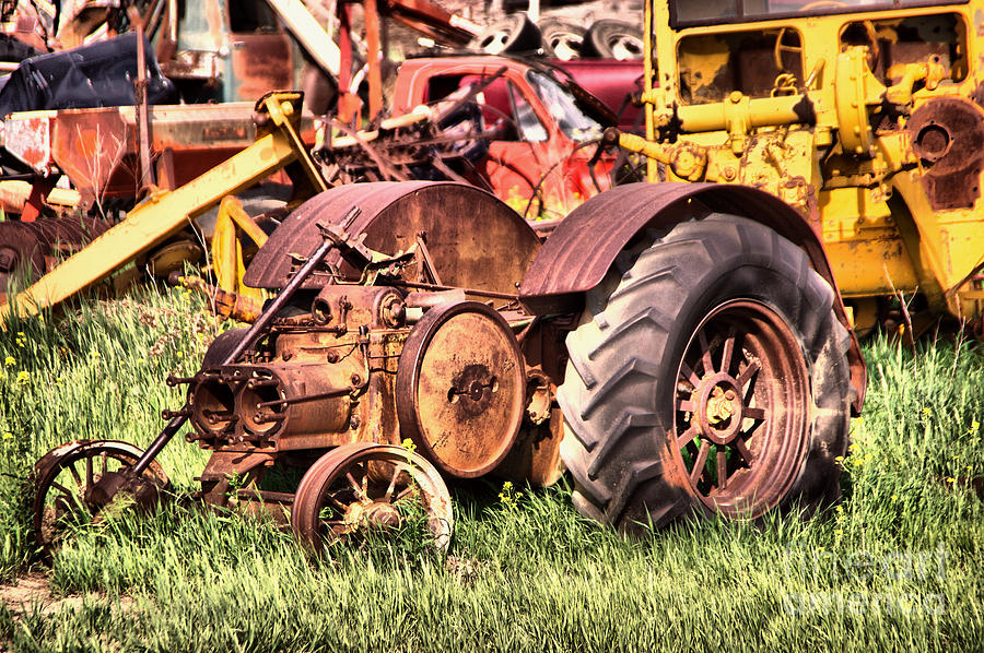 Remains of an old farm tractor Photograph by Jeff Swan