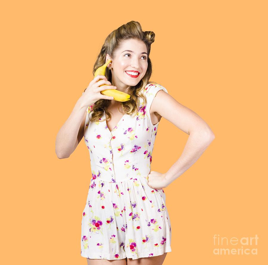 Retro pin up girl chatting on banana telephone Photograph by Jorgo Photography