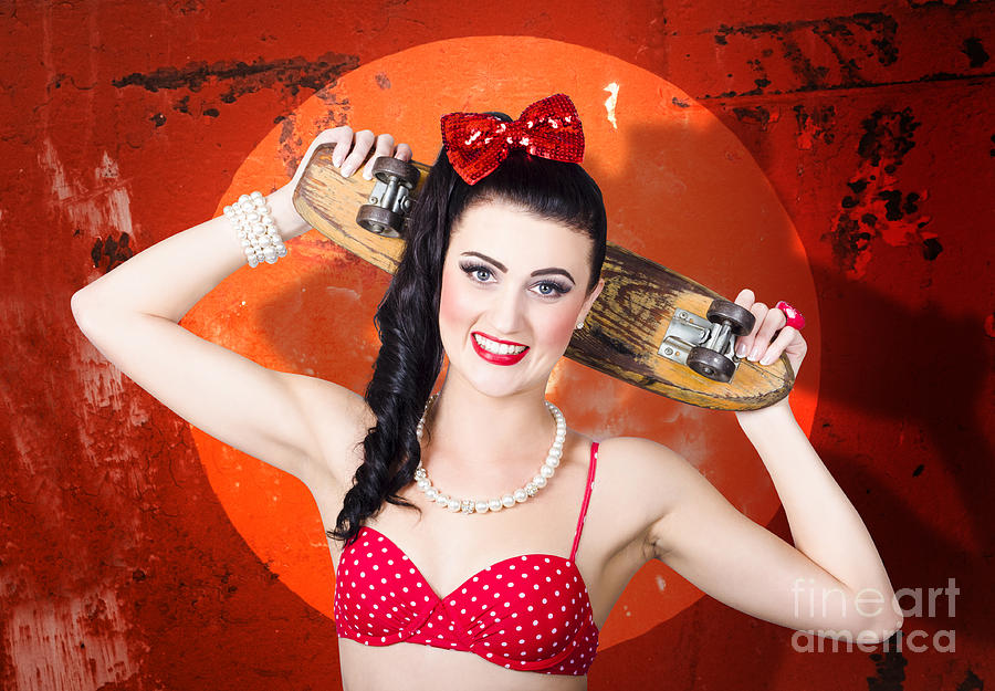 Retro pinup girl holding old wooden skateboard Photograph by Jorgo Photography