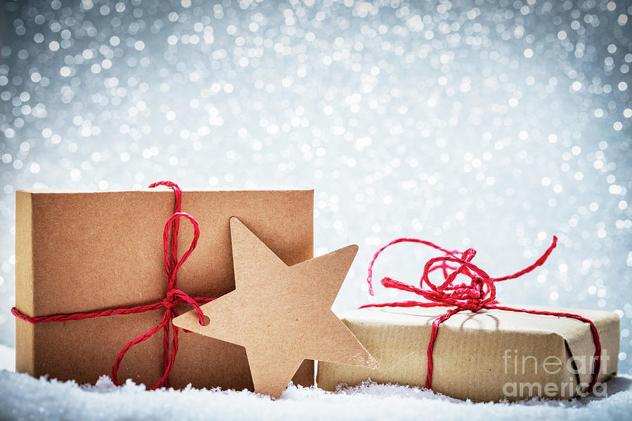 Retro rustic Christmas gifts, presents in snow on glitter background Photograph by Michal Bednarek