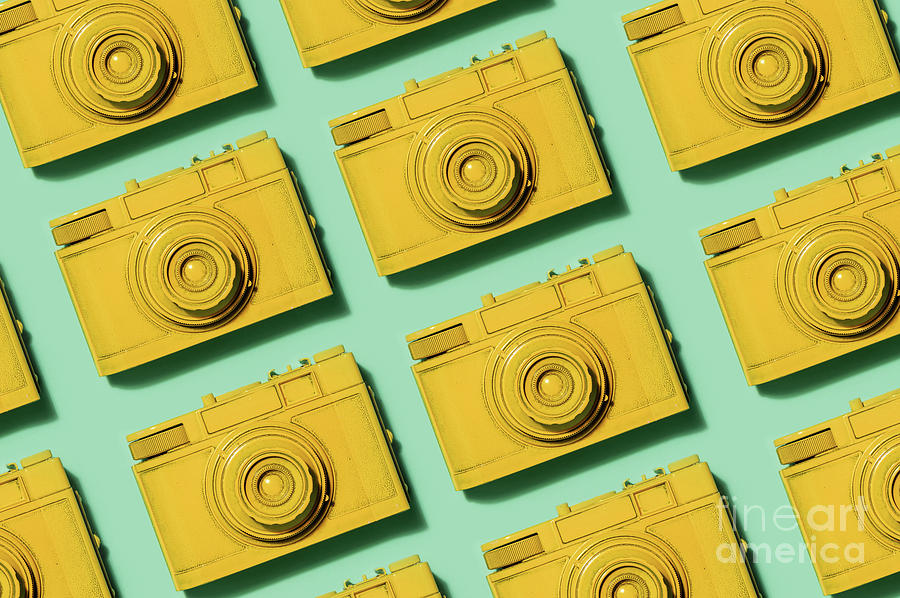Retro yellow cameras on green background Photograph by Michal Bednarek